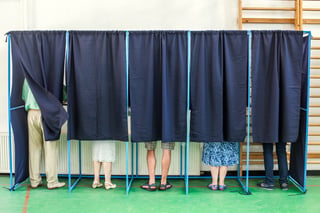 People in a voting booth