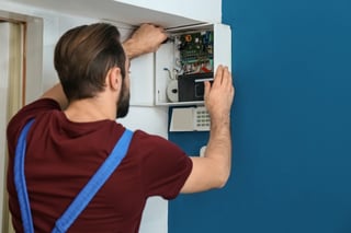 Man installing alarm system