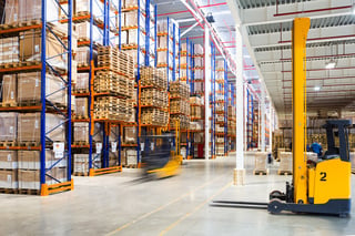 Forklifts working in warehouse