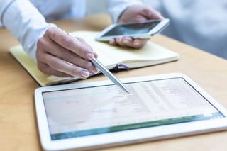 Businessperson cross-checking lists