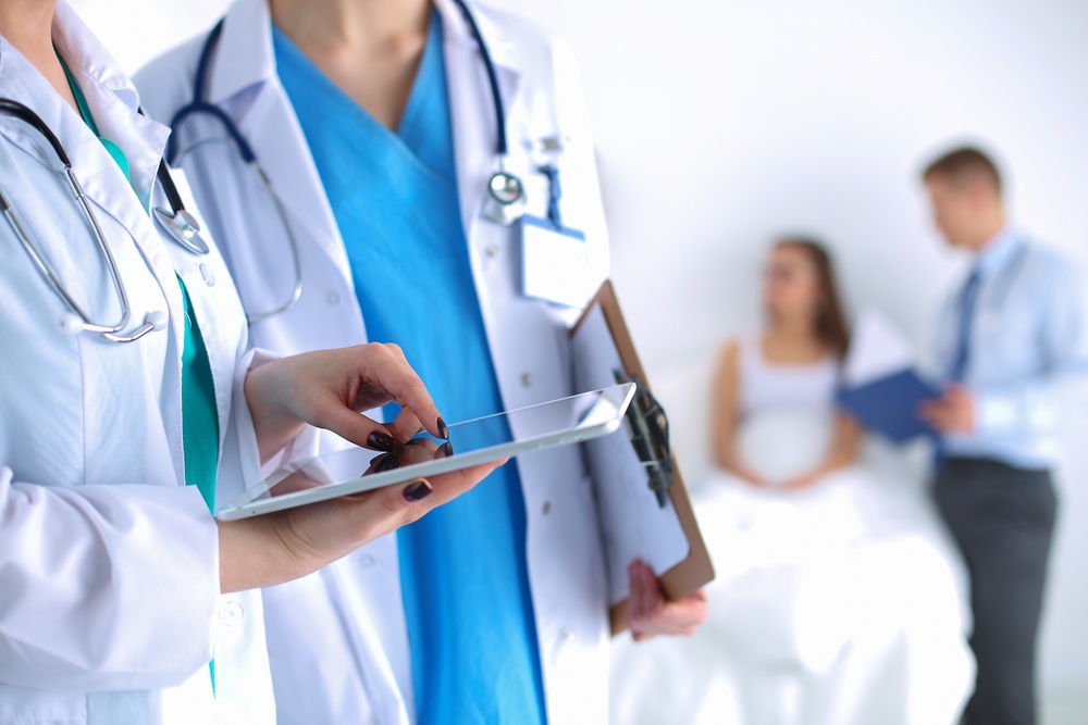 Physicians looking at a tablet